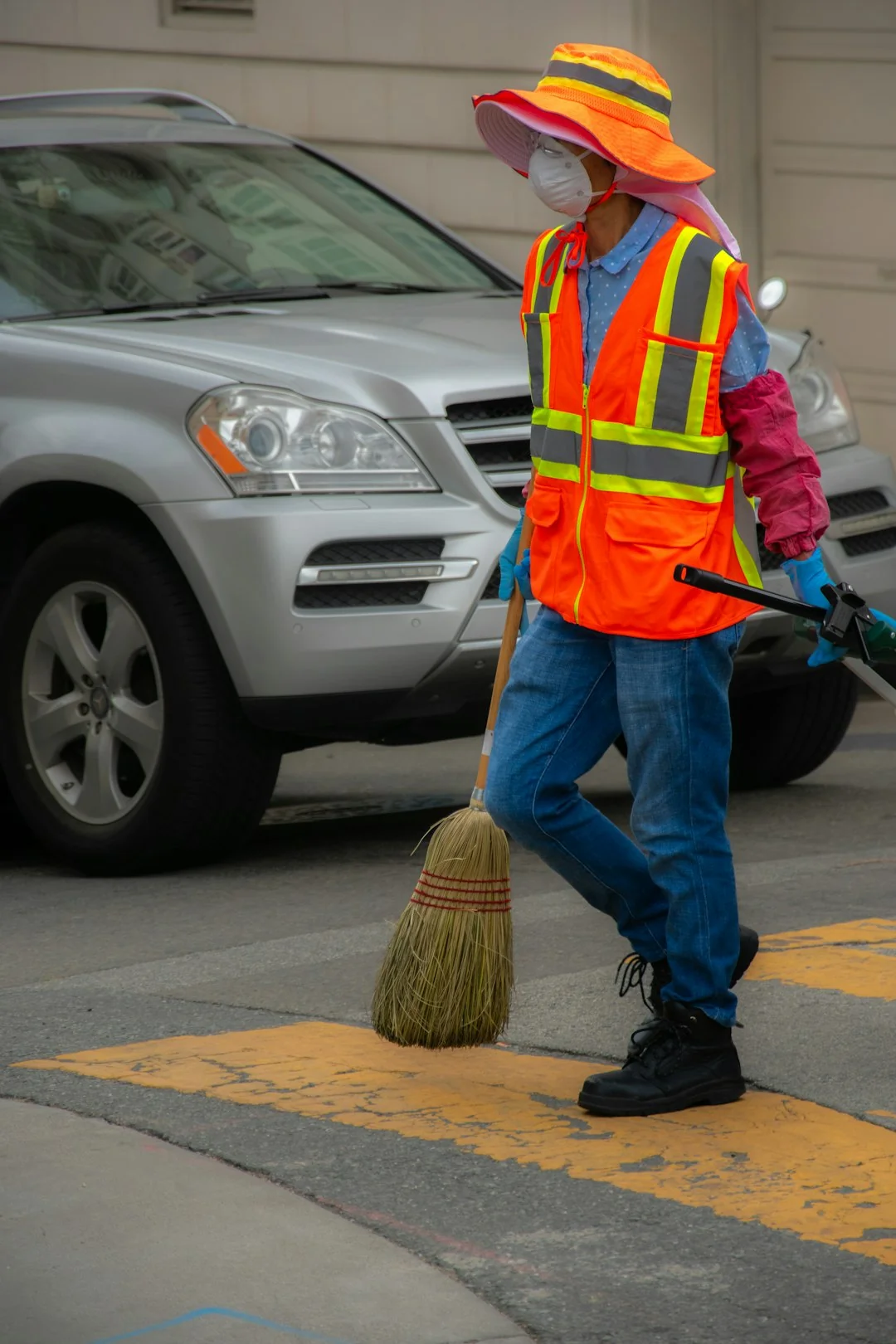 A grayscale photo of a person mopping the floor in a modern living room.